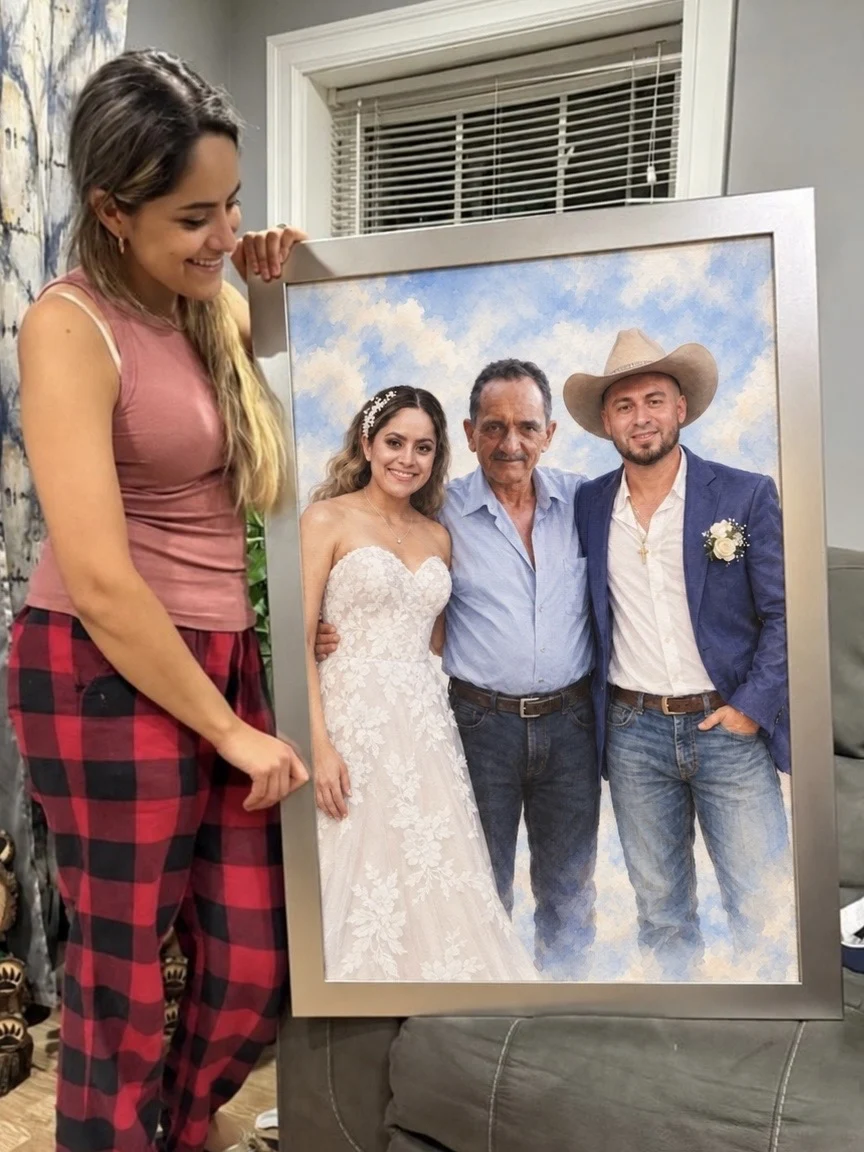 Customer holding the finished family portrait on framed canvas